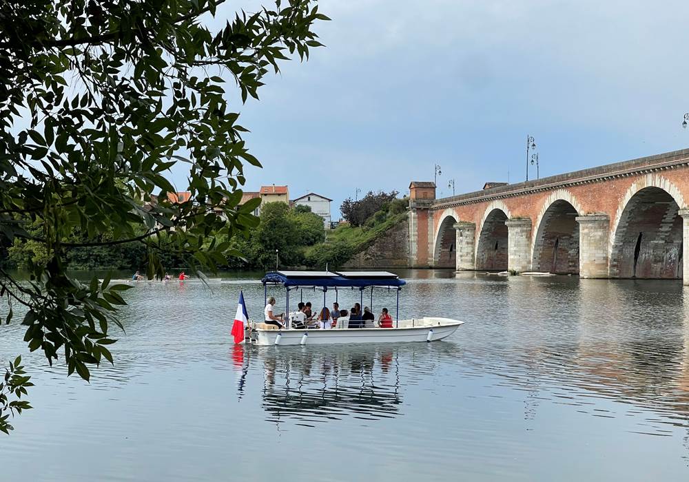 Le bateau 12 passagers Helios Confluences s'apprête à passer sous le Pont Napoléon de Moissac
