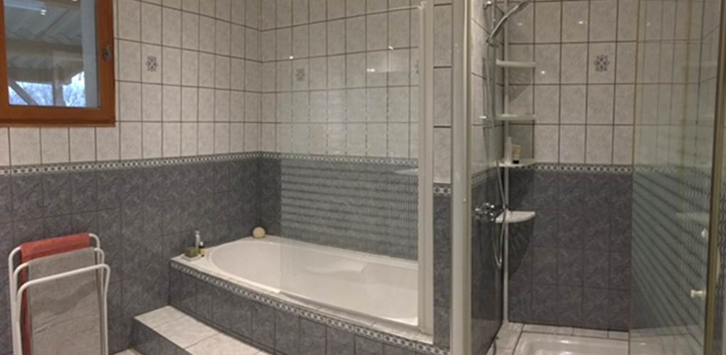Salle-de-bain avec sa baignoire et sa douche