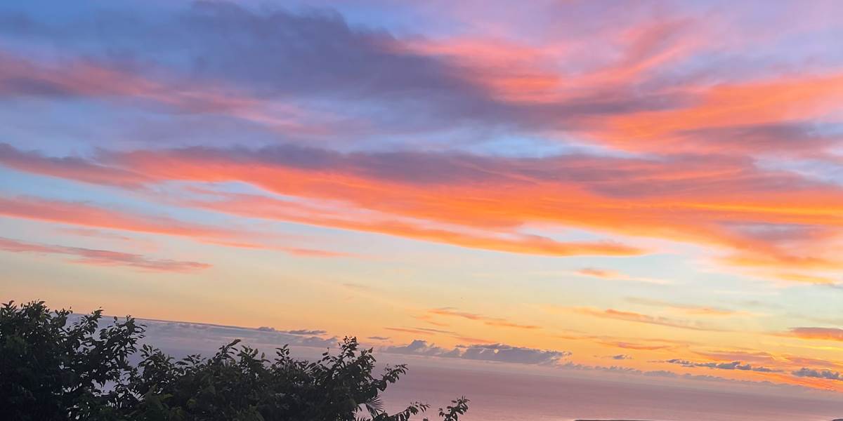 Explosion de couleurs d'un lever de soleil depuis une fenêtre de la chambre Tourmaline