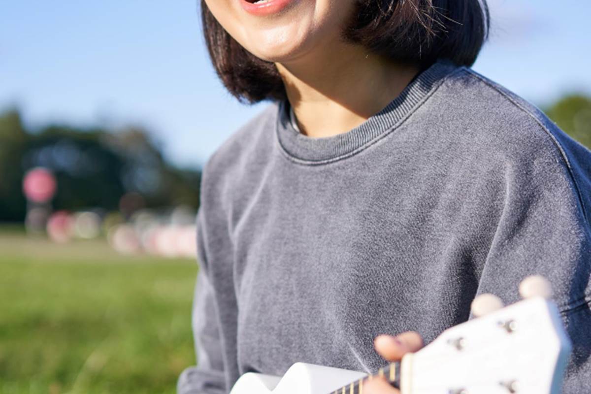 vertical-shot-smiling-asian-girl-singing-laughing-playing-ukulele-learn-how-play-instrumen