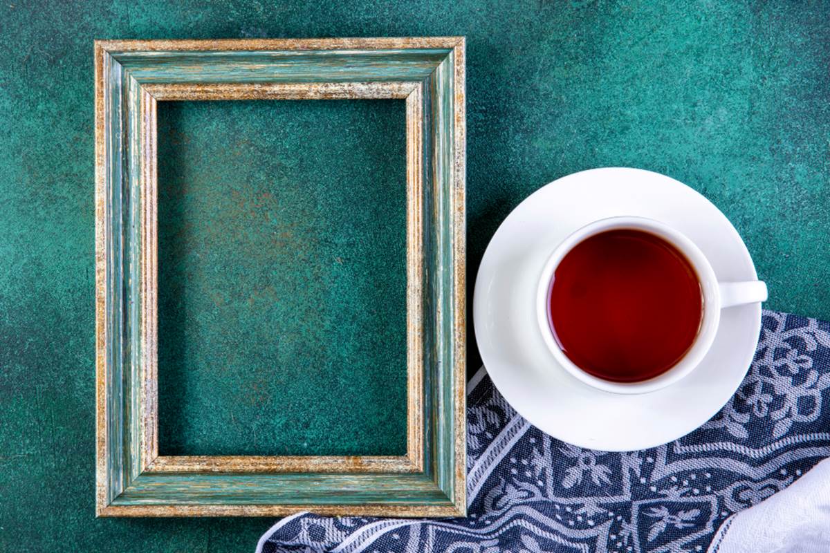top-view-copy-space-green-gold-frame-with-cup-tea-kitchen-towel-green