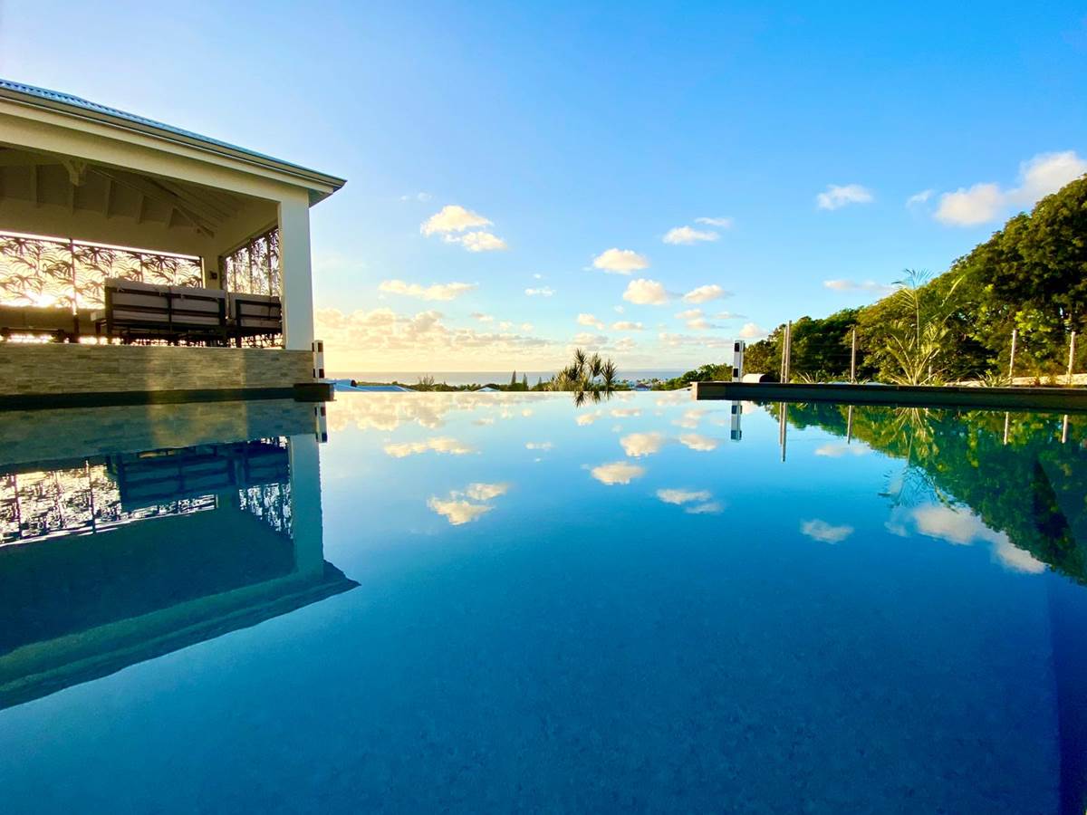Piscine à débordement vue mer avec coin salon sous le carbet