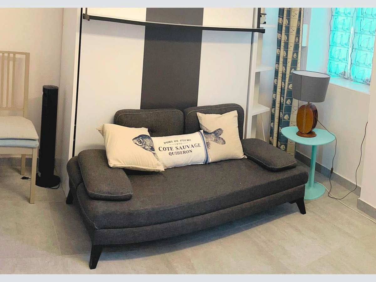 Studio – Coin salon avec charme rétais Ambiance chaleureuse et touche marine dans cet espace modulable en plein centre piéton. Confort assuré pour un séjour paisible à La Flotte