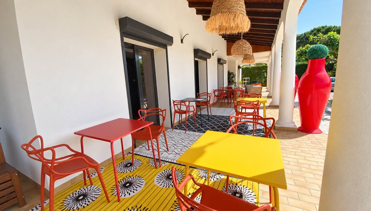 La terrasse couverte de Casa Nova, avec ses arcades et ses espaces aménagés pour les petits-déjeuners et la détente.