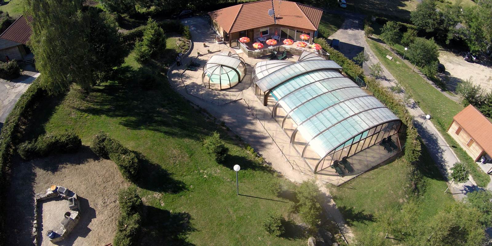 Les Chalets de la Margeride: Vue de l'Accueil, Piscines, terrasses, …et l'l'aire des barbecues
