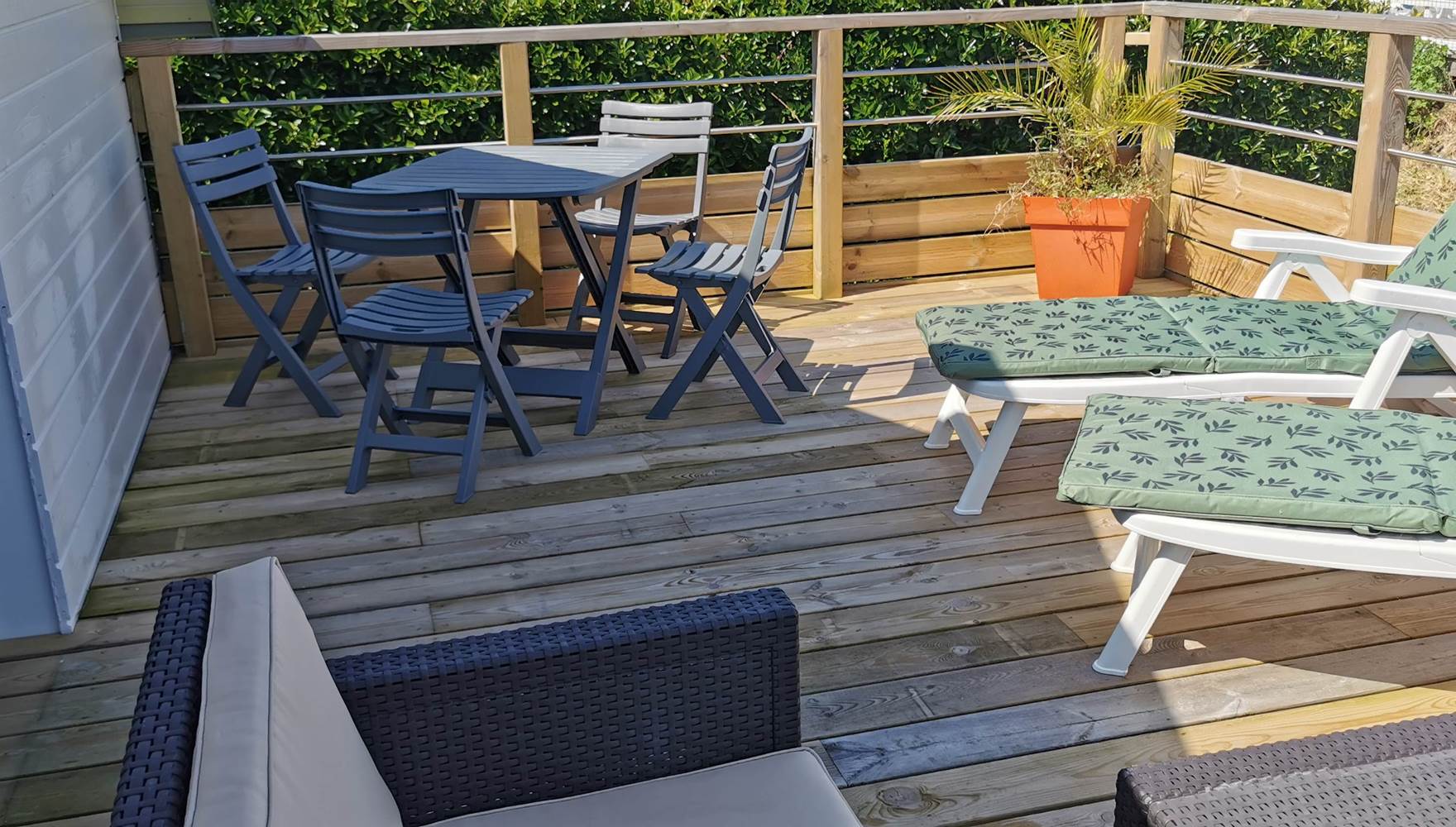 Terrasse solarium face à la mer avec transats, salon pour un séjour romantique