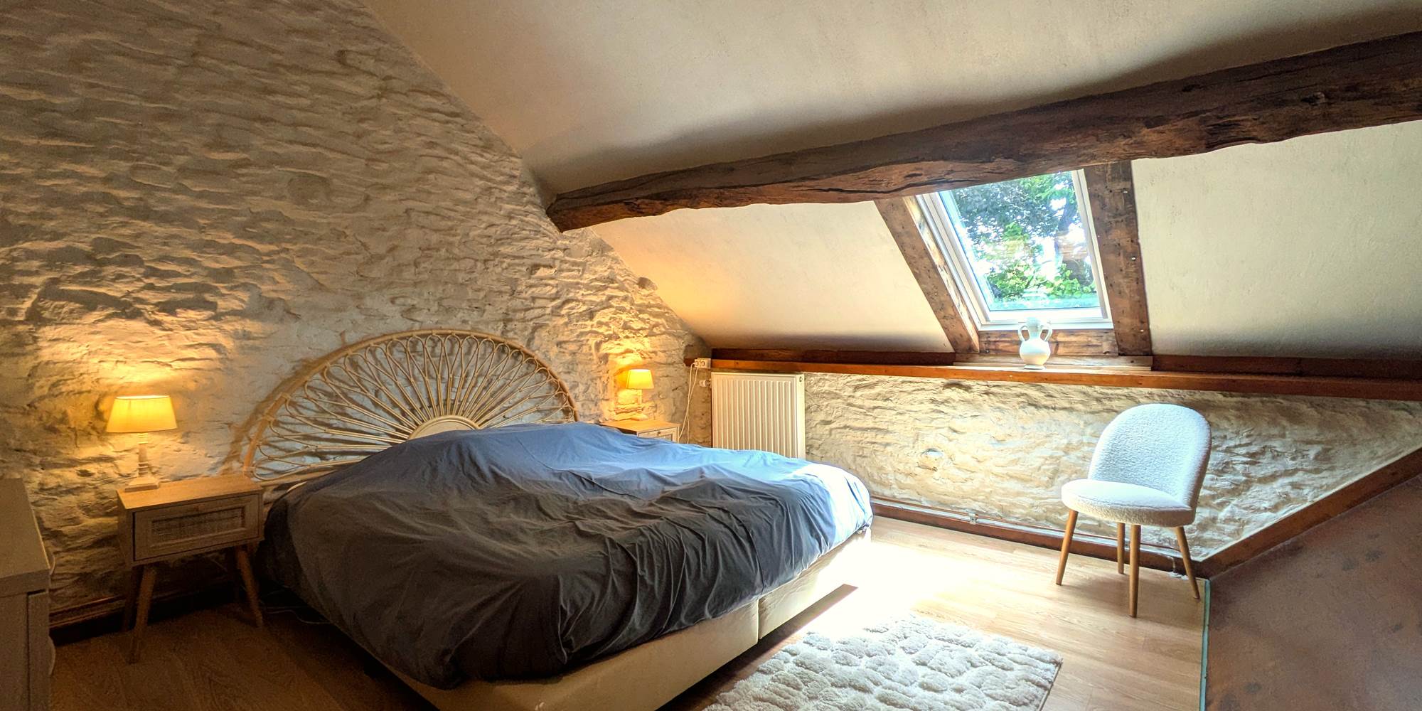 Unique king size bedroom with cathedral ceiling and exposed stone walls