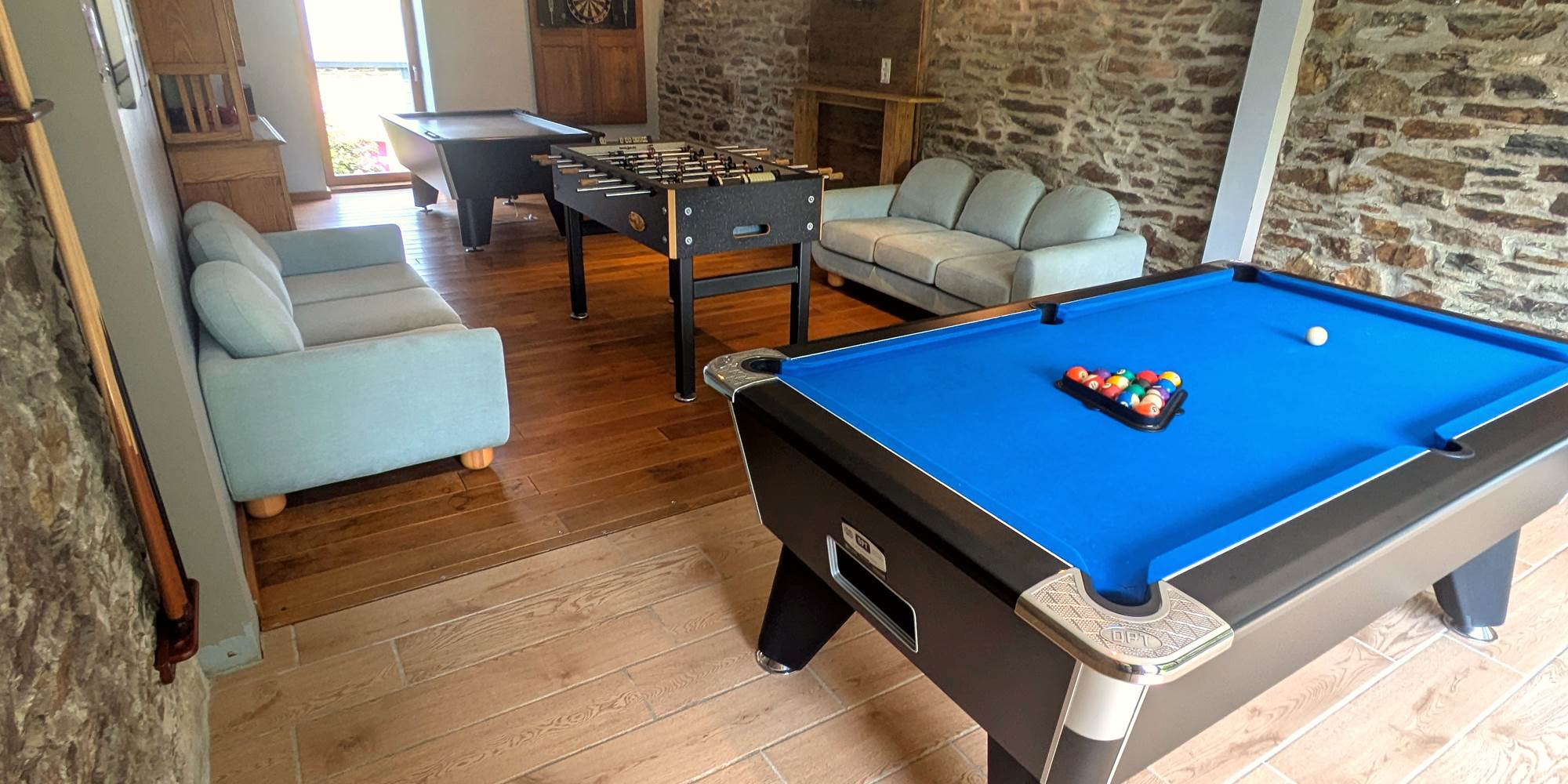 Games room with pool table, foosball, air hockey and darts in family gîte