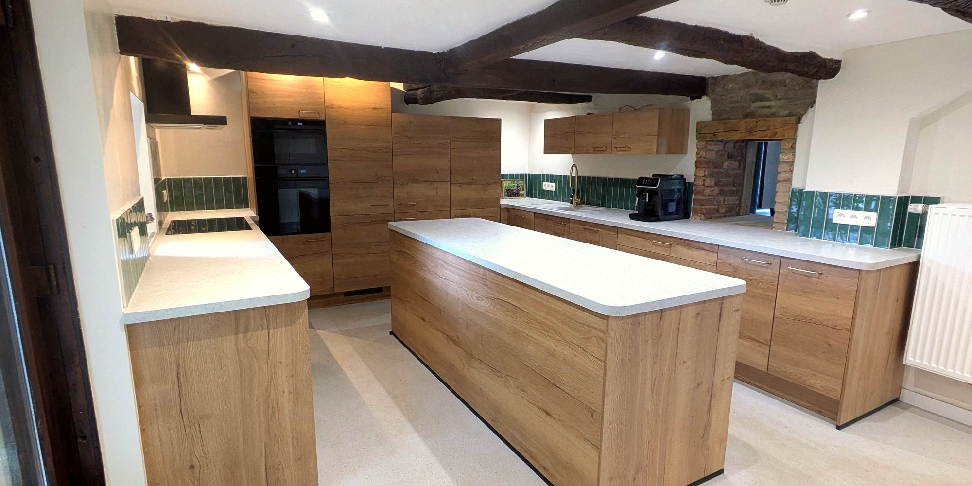 Bright open-plan kitchen connected to dining and living area in group accommodation