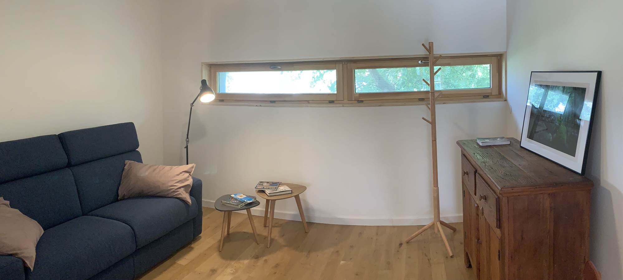 Espace salon avec un canapé, des tables basses, une commode et des chaises. L'endroit parfait pour se détendre.