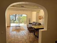 Bright living room with wide patio doors opening onto garden and pool, Villa Lou Pantaï