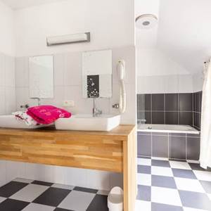 La salle de bain de la chambre Fuschia : double lavabo - baignoire / douche - toilette