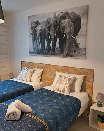 Chambre avec deux lits simples pour enfants dans une suite familiale près du Zoo de La Flèche