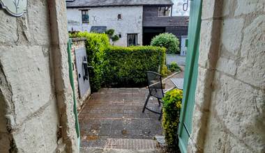 View of the front garden from the original stone entrance to Tuffeau Sunsets, Jaulnay Gites de Famille.