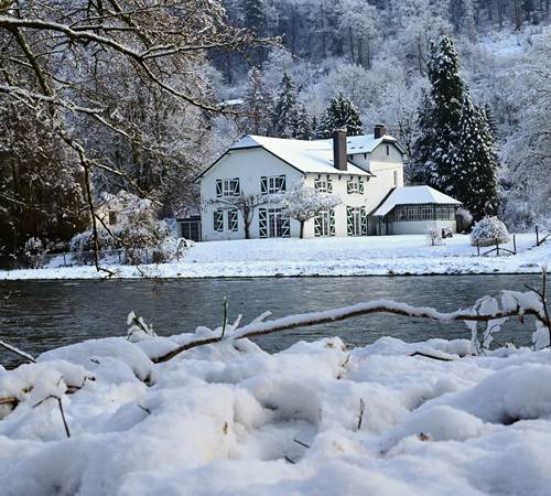 Sprookjesachtigwinterbeeld van de Amblève en de met sneeuw bedekte ecolodge-galerie