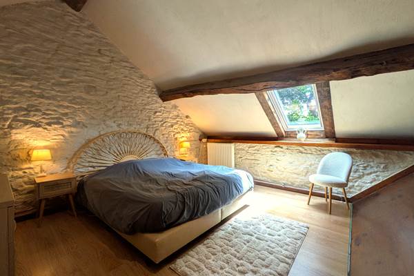 Unique king size bedroom with cathedral ceiling and exposed stone walls