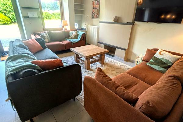 Cozy living room with soft armchairs and warm decorative touches