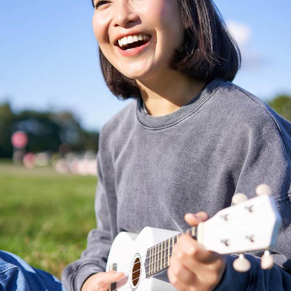 vertical-shot-smiling-asian-girl-singing-laughing-playing-ukulele-learn-how-play-instrumen-photo-gallery