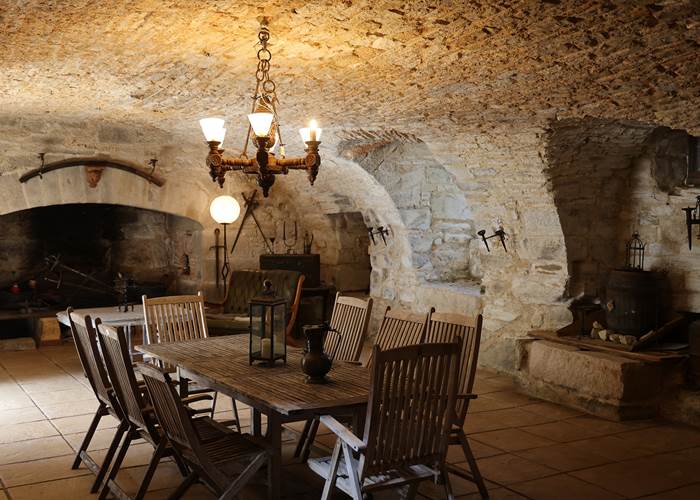 Grande salle voûtée en pierre au Château de Saint-Chamarand, espace de réception dans le Lot