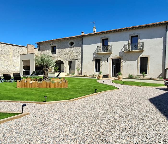 Vue extérieure des Gîtes de Monte Blanco à Montblanc dans l’Hérault, domaine rénové avec jardin, transats et ambiance printanière