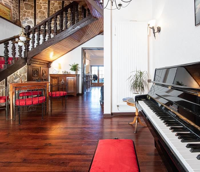 Un salon d'accueil convivial et chaleureux avec un piano pour les mélomanes