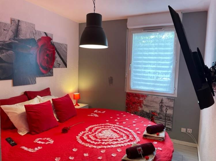 Chambre avec lit rond et télé