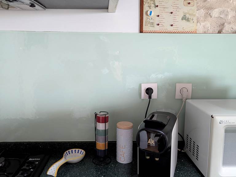 A fully-equipped kitchen, including stove, microwave, and capsule coffee maker for sharing family meals and moments at Secret de Campagne, Jaulnay Gites de Famille.