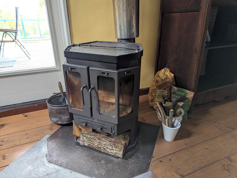 Keep warm with the rustic charm of a wood stove at Secret de Campagne, Jaulnay Gites de Famille.