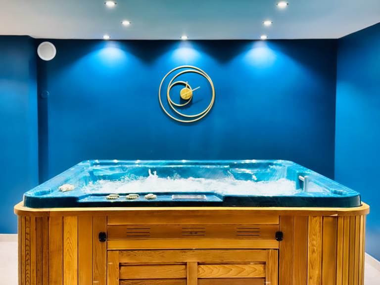 Jacuzzi en bois dans l’espace spa privatif Le Magnolia