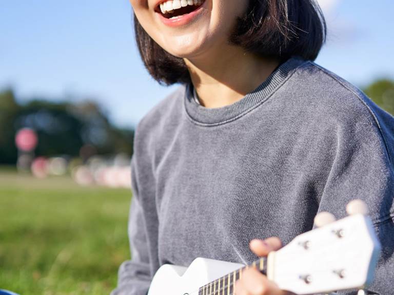 vertical-shot-smiling-asian-girl-singing-laughing-playing-ukulele-learn-how-play-instrumen