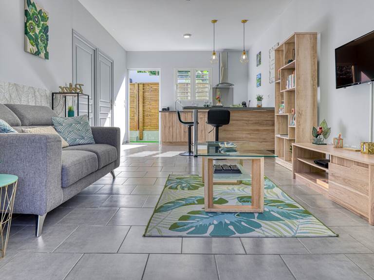 Appartement Chouchou à Hell-Bourg, avec un salon confortable, un coin repas convivial et une cuisine moderne ouverte, idéal pour un séjour à Salazie, La Réunion.