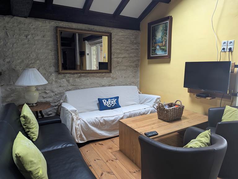 Inviting couches in the spacious open-concept living room for family moments at Secret de Campagne, Jaulnay Gites de Famille.