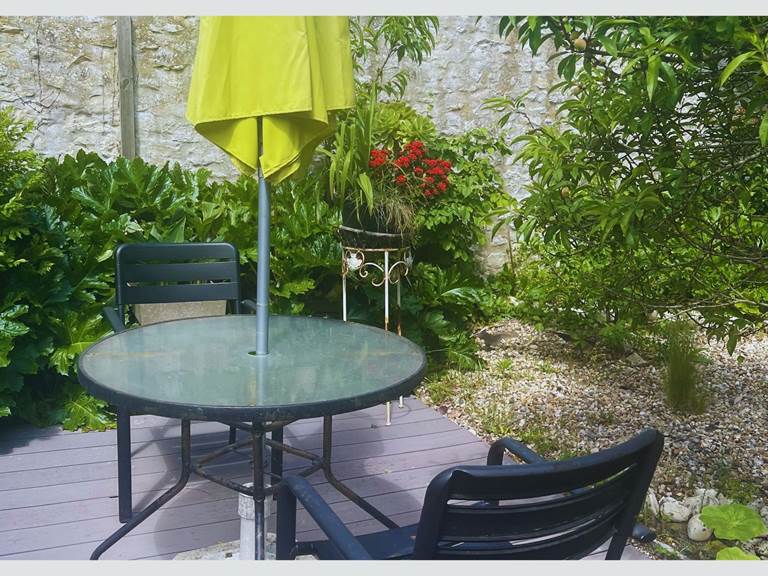 Terrasse fleurie et calme pour vos repas à l’extérieur Entouré de plantes luxuriantes et de murets en pierre, ce petit coin repas est idéal pour savourer l’ambiance douce et typique de l’île de Ré.