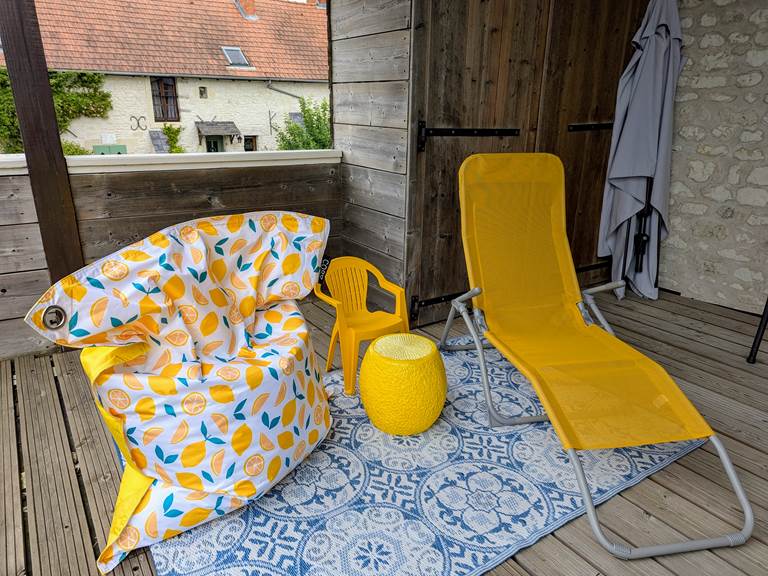 Comfy cushions for lounging on the balcony at Secret de Campagne, Jaulnay Gites de Famille.