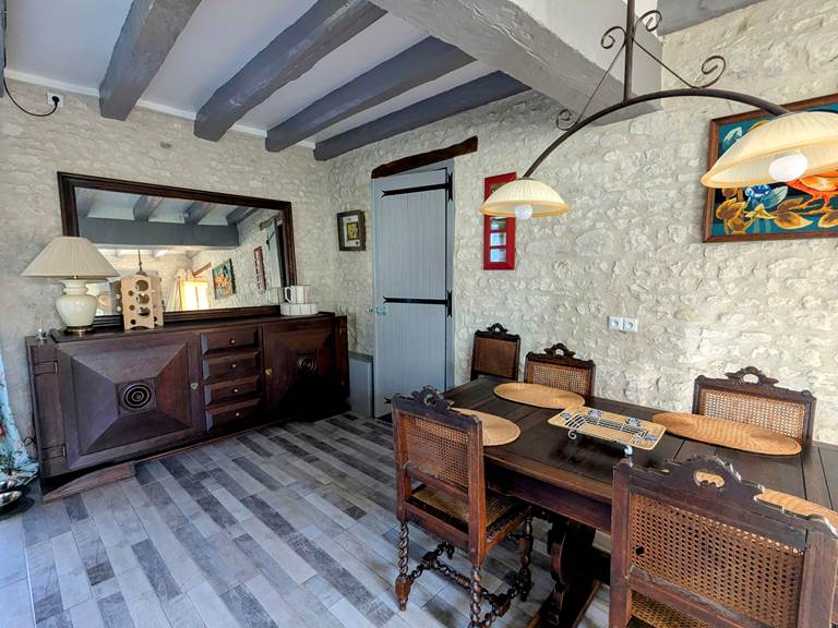 Dining table and buffet in the living room at Tuffeau Sunsets, Jaulnay Gites de Famille., for enjoying a meal with the whole family.
