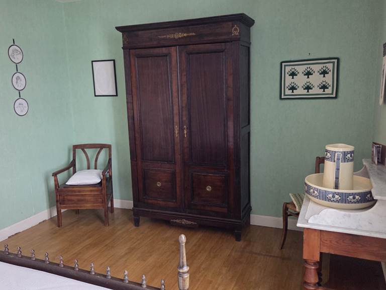 Chambre verte armoire et fauteuil