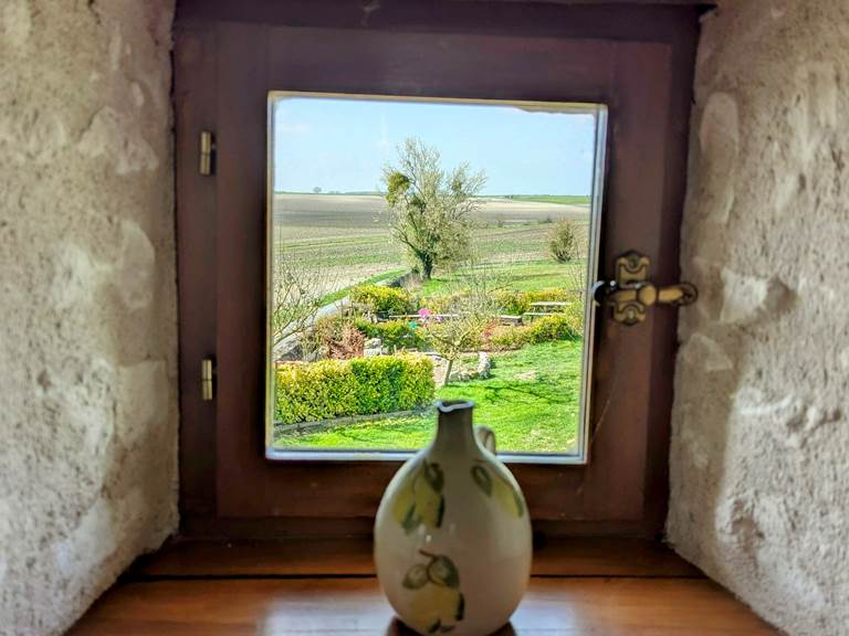 A picture perfect porthole window at Tuffeau Sunsets, Jaulnay Gites de Famille.