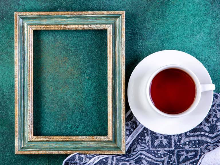 top-view-copy-space-green-gold-frame-with-cup-tea-kitchen-towel-green