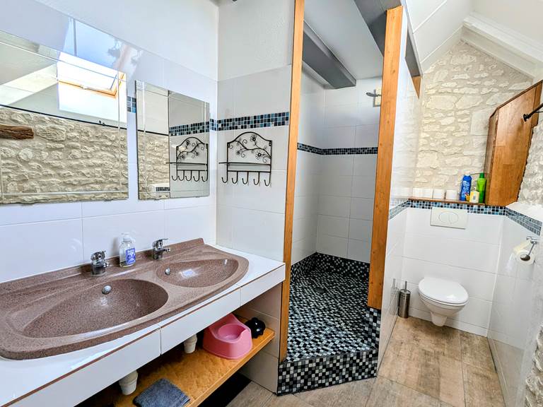 Bathroom with double sinks, shower, and water closet Tuffeau Sunsets, Jaulnay Gites de Famille..