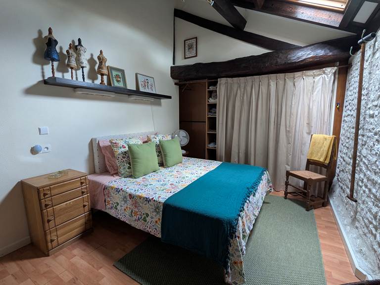 A cozy bedroom with king-size bed at Secret de Campagne, Jaulnay Gites de Famille.