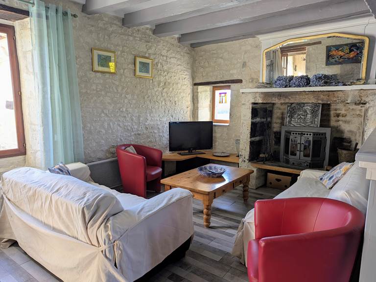 An original fireplace from the 1600s in Tuffeau Sunsets, Jaulnay Gites de Famille for comfortable winter evenings.