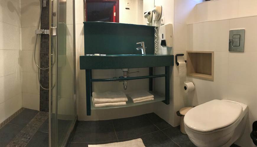 Salle de Bain privative comprenant une douche italienne, un lavabo, un sèche cheveux et toilettes. Savon, shampoing / douche, papier wc, serviettes de main et serviettes de bain.