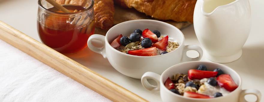 tasty-colorful-breakfast-with-oatmeal-yogurt-strawberry-blueberry-honey-milk-white-background-breakfast-bed-copy-space-top-view